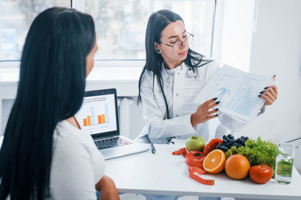 A lady nutritionist is offerring nutritional counselling on anthropometry foundations.